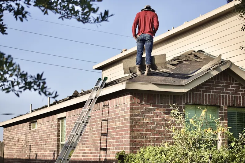 Professional roofer working on a residential roof in Arden Park Vista